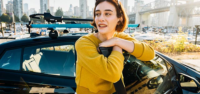 Woman leaning on open Evo car door