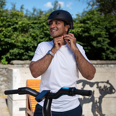 Man buckling helmet under chin